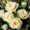 A bouquet of white roses and greenery