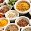 A collection of spices in small ceramic bowls
