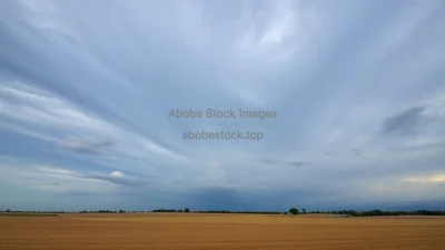 A dramatic sky over a clean agricultural landscape