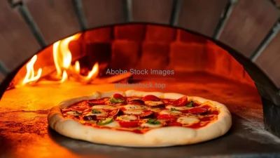 A freshly baked pizza coming out of a brick oven