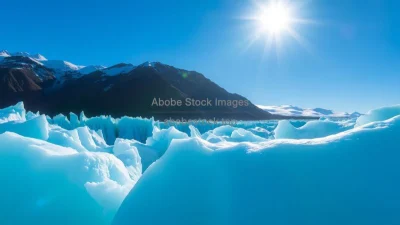 A glacier glowing blue under soft sunlight