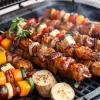 A grill covered with skewers of vegetables and meat