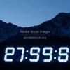 A massive digital countdown clock to emission targets projected on mountain side
