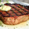 A perfectly grilled steak with herbs and butter