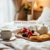 A serene breakfast in bed with tea and fruit