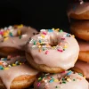 A stack of donuts covered in icing and sprinkles