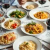 A table full of Italian pasta dishes and wine