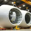 Assembly of wind turbine nacelles in a large industrial hall cranes lifting components vertical framing