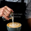 Barista pouring milk for latte art