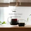 Black drip coffee in glass carafe and mug