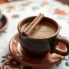 Café de olla in clay mug with cinnamon stick