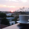 Cappuccino at sunrise on balcony railing