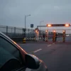 Car at a border crossing checkpoint security barriers and guards tension