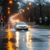 Car crossing a flooded street during heavy rain storm dramatic reflections