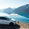 Car parked beside a crystal clear mountain lake perfect reflection