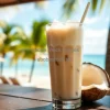 Coconut iced latte in tall glass with coconut pieces