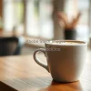 Coffee latte art in a white ceramic cup on wooden table