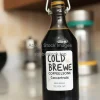 Cold brew coffee concentrate in dark glass bottle with label