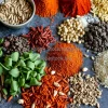Colorful assortment of spices herbs and seeds arranged neatly on a table