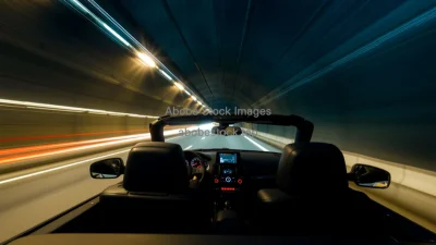 Convertible driving through a tunnel with light trails long exposure effect