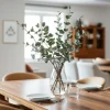 Dining area with eucalyptus branches in a glass vase