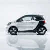 Electric compact car in a minimalist white environment reflection on floor