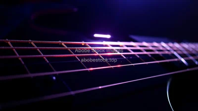 Electric guitar strings vibrating under strobe light physics of sound and resonance dramatic close up