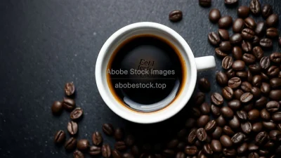 Espresso shot surrounded by scattered roasted coffee beans