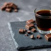Espresso with dark chocolate pieces on slate board