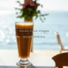 Frappe coffee in tall glass with foam