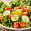 Fresh salad with leafy greens cherry tomatoes cucumber and olive oil dressing