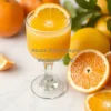 Freshly squeezed orange juice in a glass next to sliced citrus fruits