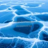 Frozen abstract wave forms on icy lake