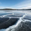 Frozen lake detail with cracks and reflections