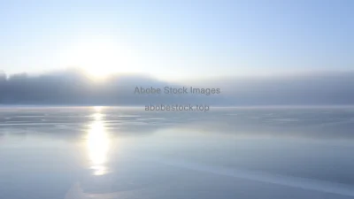 Frozen lake reflecting pale winter sunlight