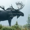 Giant moose standing in misty northern forest