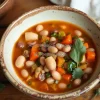 Healthy bean and vegetable stew in a rustic bowl on a wooden table