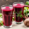 Healthy beet and carrot juice in glasses with fresh roots nearby