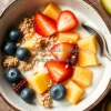 Healthy coconut yogurt bowl with tropical fruits and seeds
