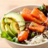 Healthy colorful poke bowl with salmon avocado and seaweed