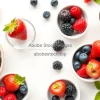 Healthy fresh berries in small bowls on a light background