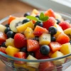 Healthy fruit salad in a large glass bowl with colorful variety