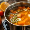 Healthy homemade vegetable broth simmering in a large pot