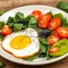 Healthy protein rich breakfast with eggs spinach and tomatoes