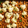 Healthy roasted cauliflower and chickpeas on a baking tray
