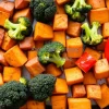 Healthy roasted vegetable tray with sweet potatoes broccoli and peppers