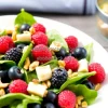 Healthy spinach and berry salad with nuts and vinaigrette