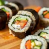 Healthy sushi rolls with vegetables and brown rice on a wooden board