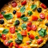 Healthy veggie loaded frittata in a cast iron pan
