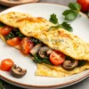 Healthy veggie omelette with spinach mushrooms and tomatoes